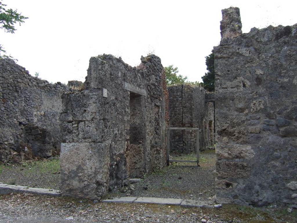 IX.9.6 Pompeii. May 2006. East wall of entrance corridor with doorway to shop at IX.9.7.
