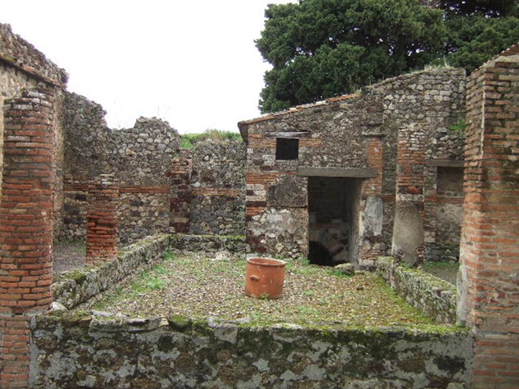 IX.9.c Pompeii. December 2005. Peristyle, looking east. According to Jashemski, the open area was enclosed on the north, west, south and part of the east sides by a portico. It was supported by four columns and one engaged column, and a double pillar at the south-west corner. See Jashemski, W. F., 1993. The Gardens of Pompeii, Volume II: Appendices. New York: Caratzas. (p.248)
