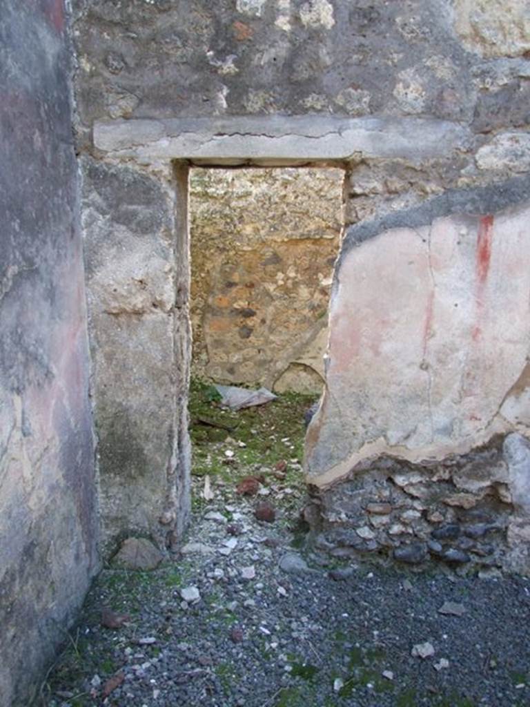 IX.9.d Pompeii. March 2009. Room l, triclinium/oecus.
Looking towards a small doorway in west wall, leading to room m.
According to NdS, originally the oecus would have had a doorway linking to the adjacent cubiculum, then the doorway was reduced it seemed to a small window.
In the centre of the west wall a painting of Io and Argo was recognised.
(See Helbig, W., 1868. Wandgemälde der vom Vesuv verschütteten Städte Campaniens. Leipzig: Breitkopf und Härtel. (no.131-34))
Io was seen sitting on the left, turning her head to the right to look at Argo, who in this painting was armed with a spear.
The figure of Argo was badly damaged, while that of Io was better preserved, wearing a necklace, yellow chiton without sleeves, a purple mantle wrapped around her legs.
Average height of figures was 0.48m.
See Notizie degli Scavi, 1889, p.132.