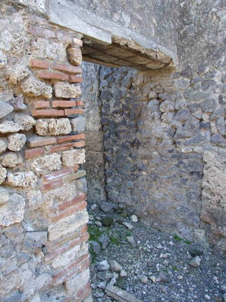 IX.9.d Pompeii. March 2009. Doorway to rooms h and i.
Room with stairs to upper floor, and latrine underneath.
On the left of the doorway, on the wall of the atrium, a graffito was found. It read –
CTXXXV
PLXXXVII