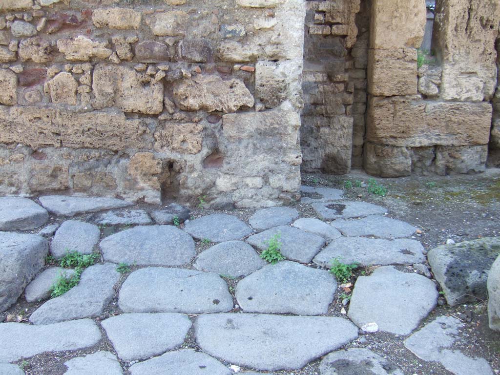 Modern bridge support (on left) is blocking the vicolo between IX.14 and IX.10. May 2010.
The brickworks, in centre, are the remains of a water tower. Large stone blocks, to right, are the corner of IX.10.2.
