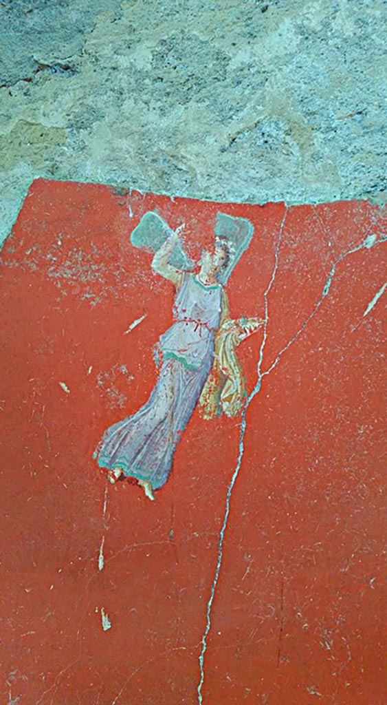 IX.12.6 Pompeii. 2016/2017. 
Room “m”, painting of flying figure from south side of central painting on west wall. 
Photo courtesy of Giuseppe Ciaramella.

