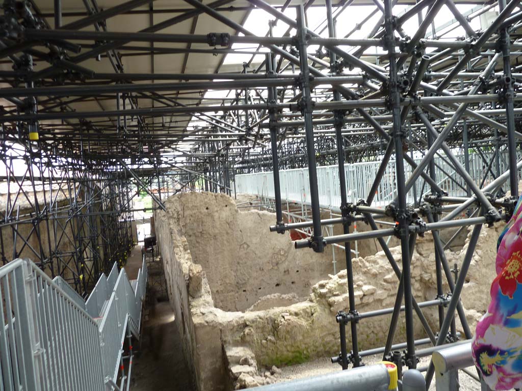 IX.12.B/IX.12.9 Pompeii. May 2010.
Looking south along roadway between IX.13 and IX.12 from excavated north-east corner of insula IX.12, with room “a”, on right.