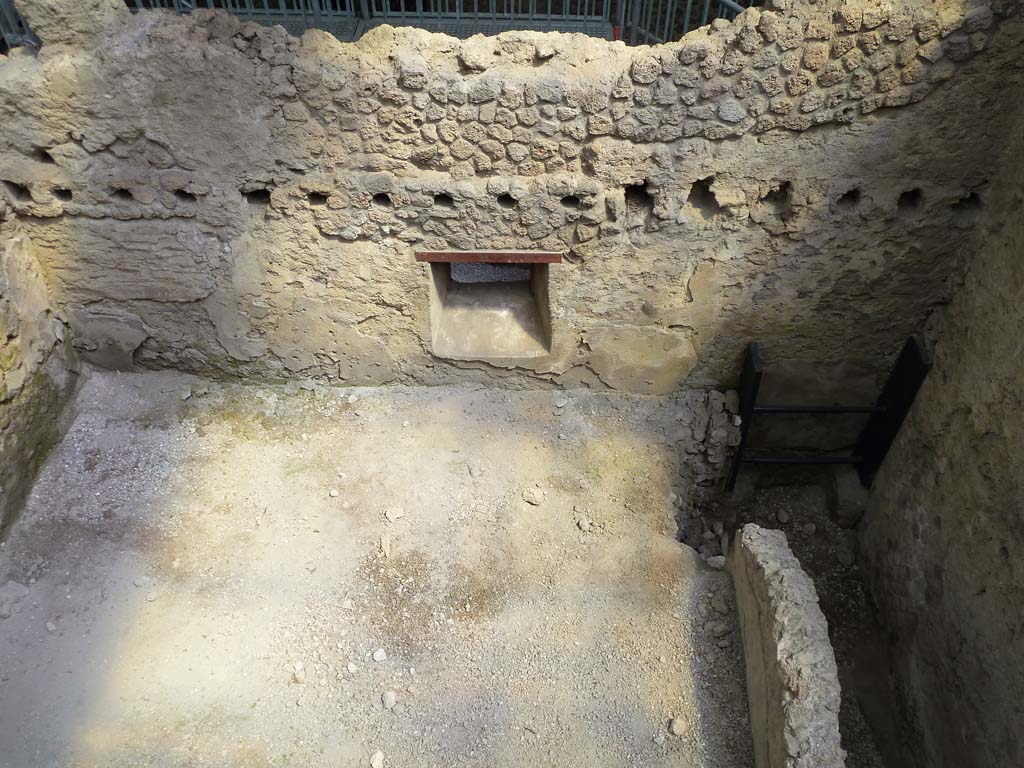 IX.12.B/IX.12.9 Pompeii. May 2010. Room “a”, east wall with window onto vicolo. Not fully excavated.
Part of the collapsed south wall and the latrine can be seen on the right.