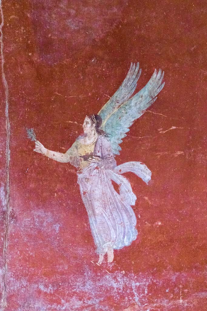 IX.13.1-3 Pompeii. October 2021.
Room 13, detail of floating figure from east wall. Photo courtesy of Johannes Eber.