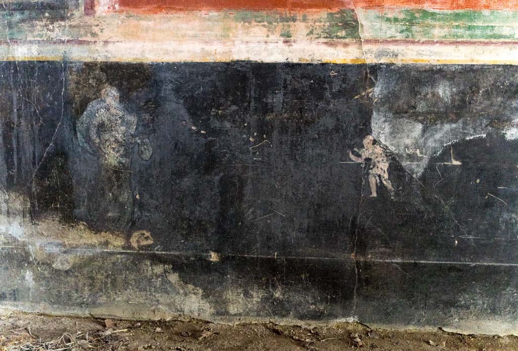 IX.13.1-3 Pompeii. October 2021. Room 13, detail from black zoccolo on east wall. Photo courtesy of Johannes Eber.