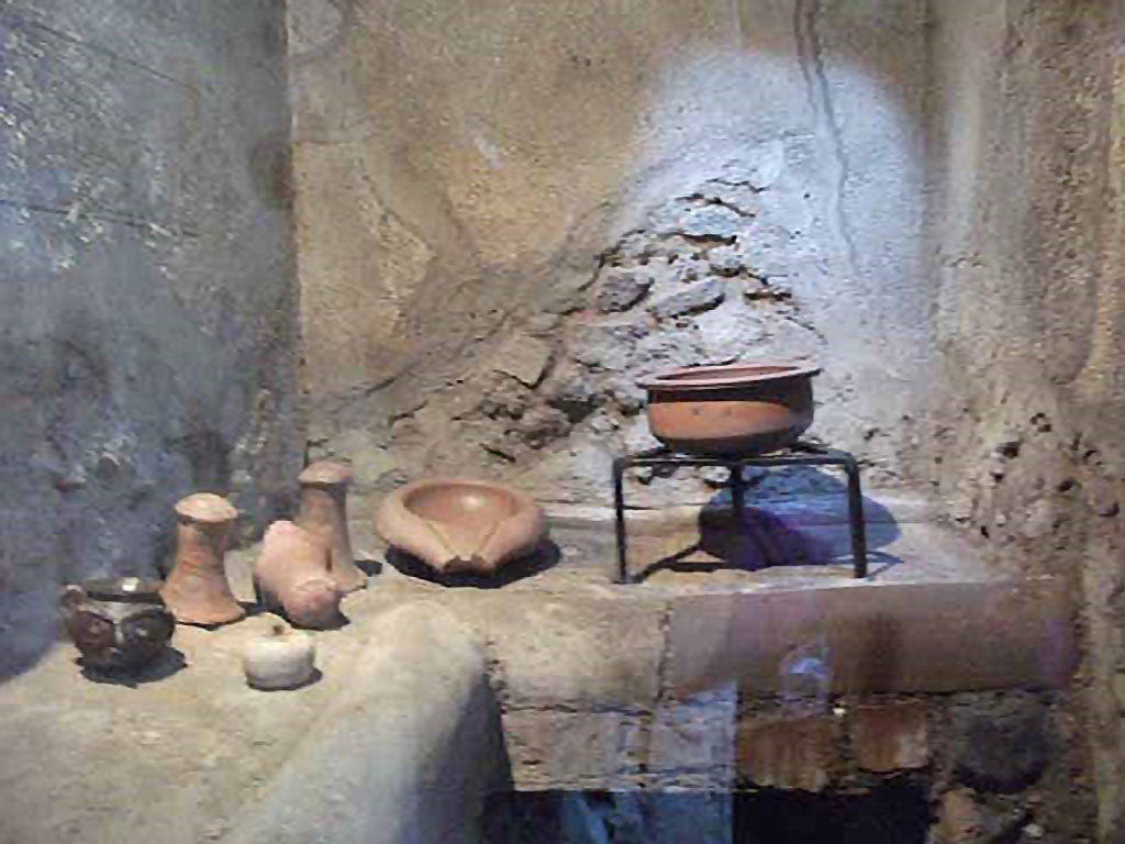 IX.13.1-3 Pompeii. May 2010. Room 23, kitchen hearth with cooking utensils.