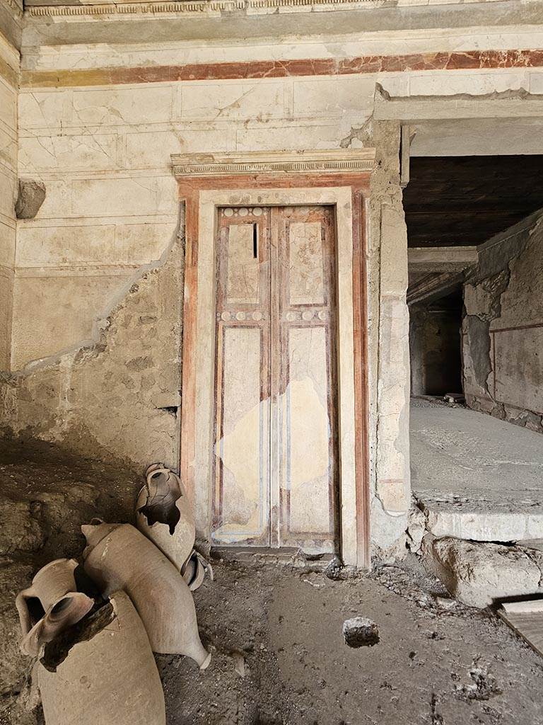 IX.13.3 Pompeii. November 2024.
Room 1, painted doorway in north-west corner. Photo courtesy of Annette Haug.