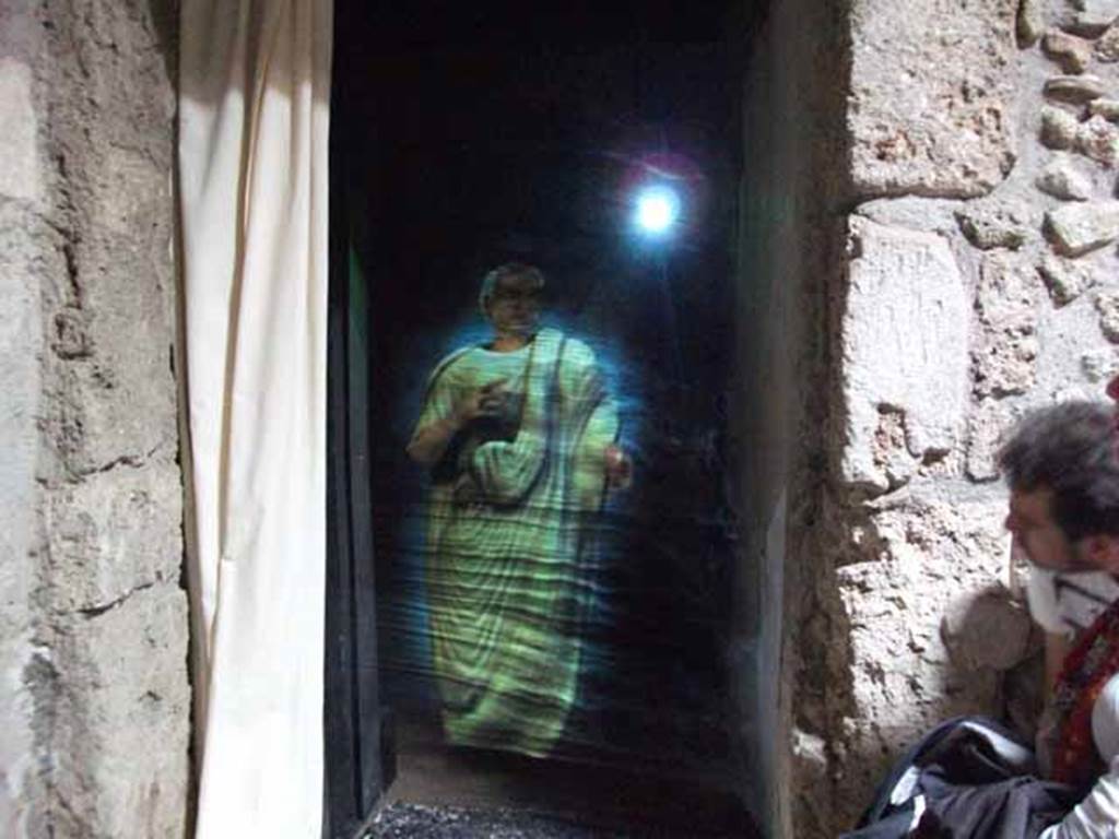 IX.13.1-3 Pompeii. May 2010. Doorway to room 5, and hologram of Julius Polybius.
