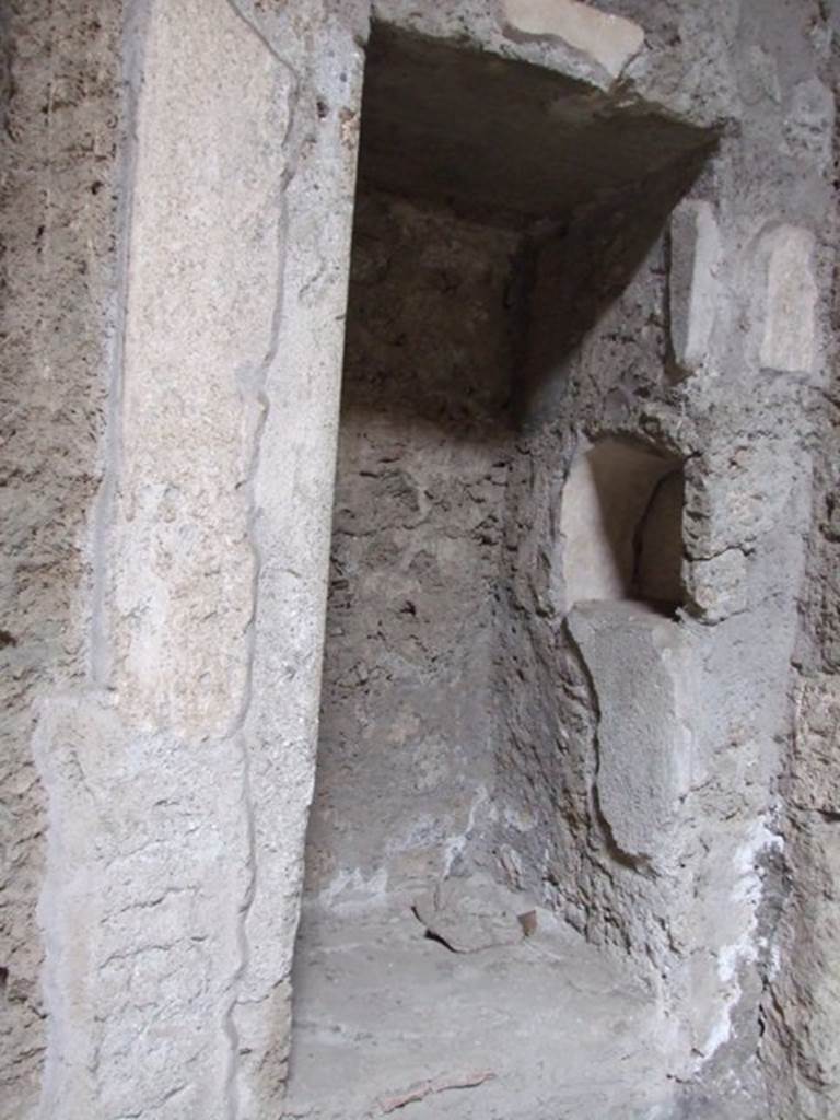 IX.13.1-3 Pompeii. March 2009. Room 2, north-east corner of atrium.
Recess with 1 niche above, and 1 niche in east side.