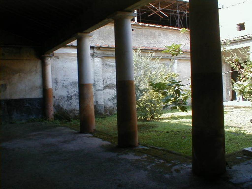 IX.13.1-3 Pompeii. September 2004. Room 9, looking west along south portico.