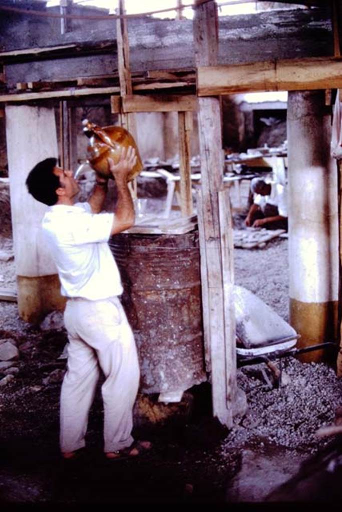 IX.13.1-3 Pompeii. 1972. Drink during excavations. Photo by Stanley A. Jashemski.
Source: The Wilhelmina and Stanley A. Jashemski archive in the University of Maryland Library, Special Collections (See collection page) and made available under the Creative Commons Attribution-Non Commercial License v.4. See Licence and use details. J72f0464