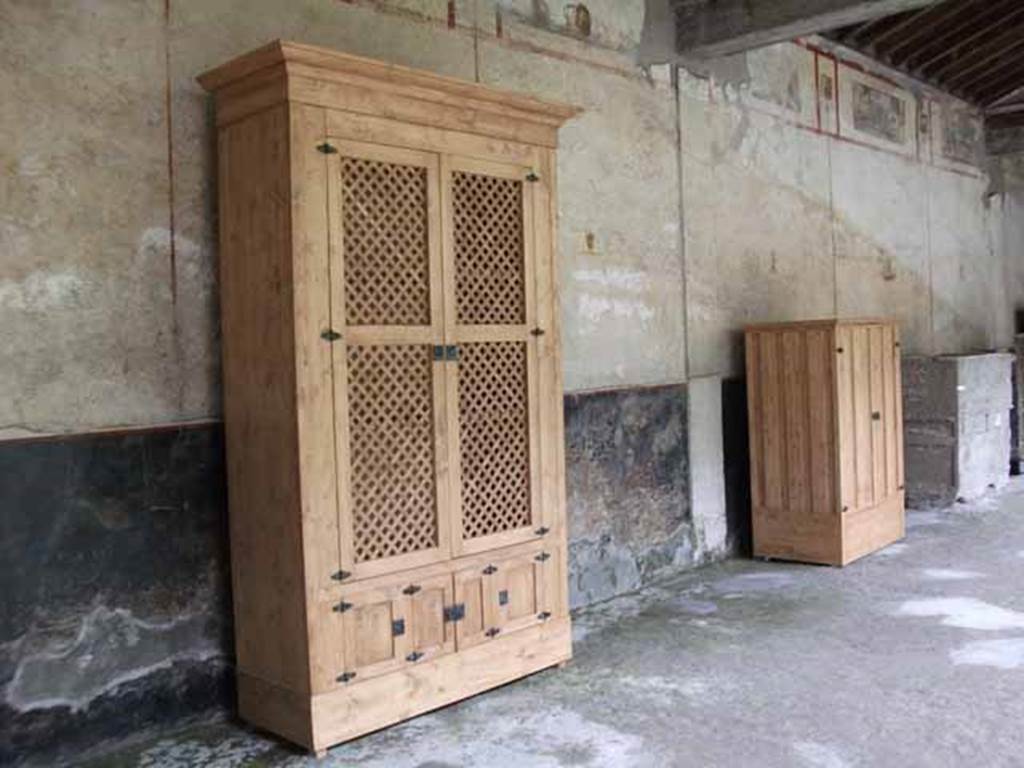 IX.13.1-3 Pompeii. May 2010. Room 9, east portico, with reproduction cupboards.