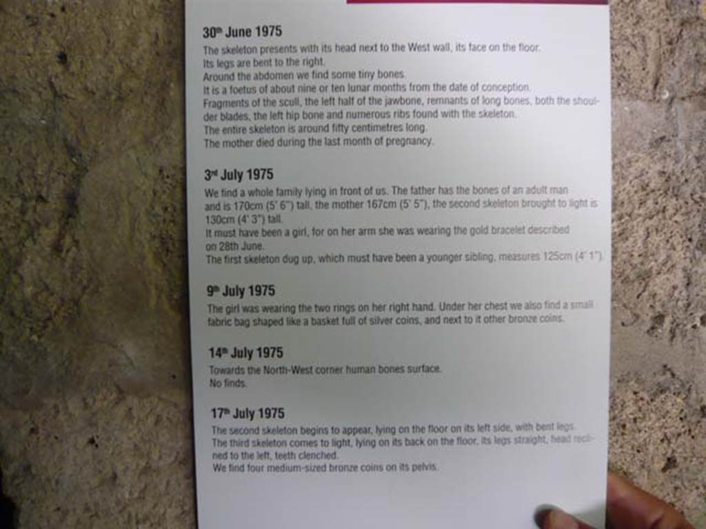 IX.13.1-3 Pompeii. May 2012. Room 10, information card with regard to finding of the skeletons. Photo courtesy of Buzz Ferebee.