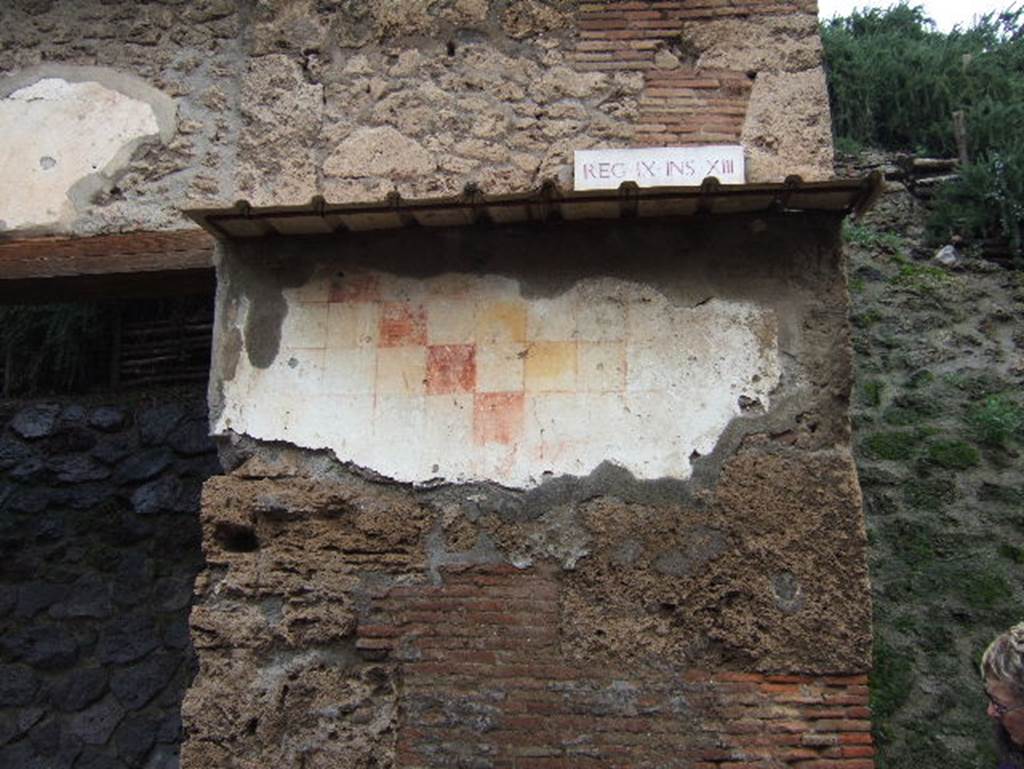 IX.13.6 Pompeii.  December 2005. Plaster with chessboard pattern to east of entrance.