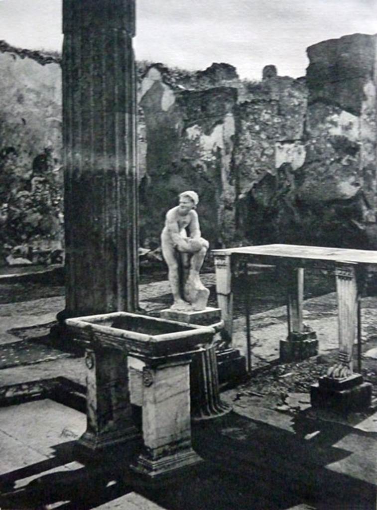 IX.14.4 Pompeii. Old undated photograph. Tetrastyle atrium B. Impluvium with marble table (e), basin (d), puteal and satyr fountain statue (c).
