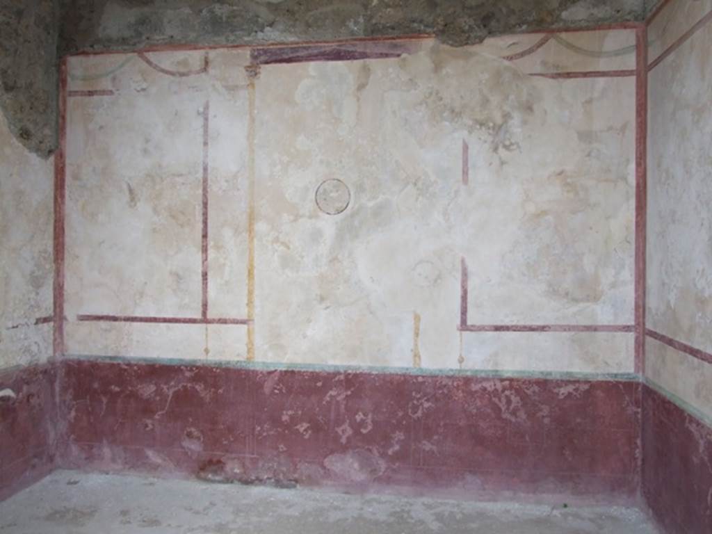 IX.14.4 Pompeii. December 2007. Room E on east side of atrium. East wall. East wall. 
According to Sogliano, this cubicula had each of its walls decorated with three large panels.
The panels had a white background, the base of the wall was painted red. In the middle of the central panel of the east wall was the only preserved medallion (dia. 0.21m). It was enclosed in a red circle and showed the head of two figures, one male and one female on a blue background. These may have been of Mars and Venus. In the middle of a side panel was a flying eagle with a rabbit between its claws. See Notizie degli Scavi, 1905, (p.253).