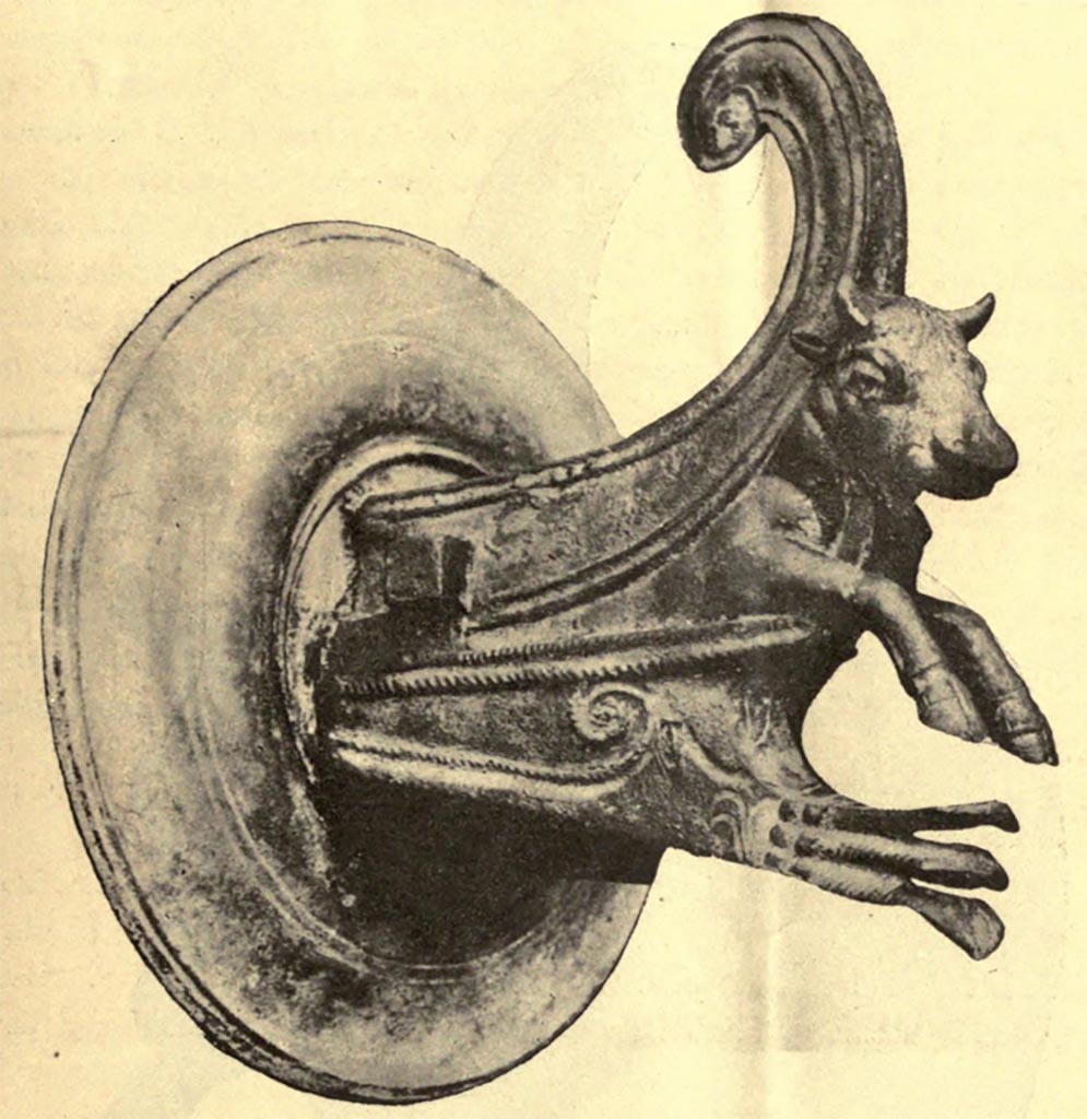 IX.14.4 Pompeii.
One of a pair of bronze fittings (borchia figurata), from south wall of atrium B.
See Notizie degli Scavi di Antichità, 1905, (p. 255, fig.7)