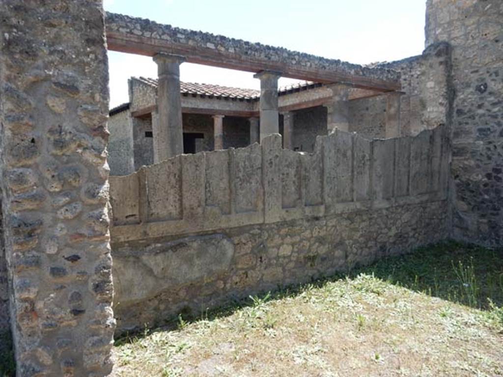 IX.14.4 Pompeii. May 2017.
Triclinium, looking south-west towards the side of the parapet wall showing the plaster-cast of the wooden shutters.
Photo courtesy of Buzz Ferebee.