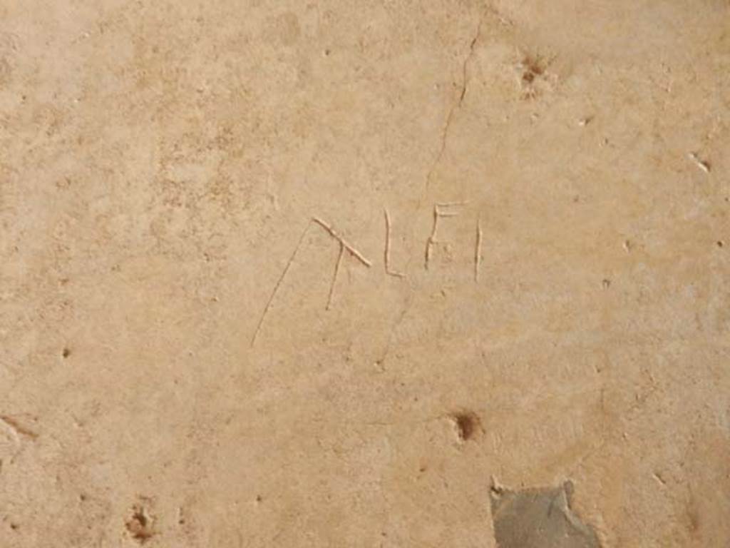 IX.14.4 Pompeii. May 2017. Graffito under the staircase on north side of peristyle.
This reads Alfi.
Photo courtesy of Buzz Ferebee.