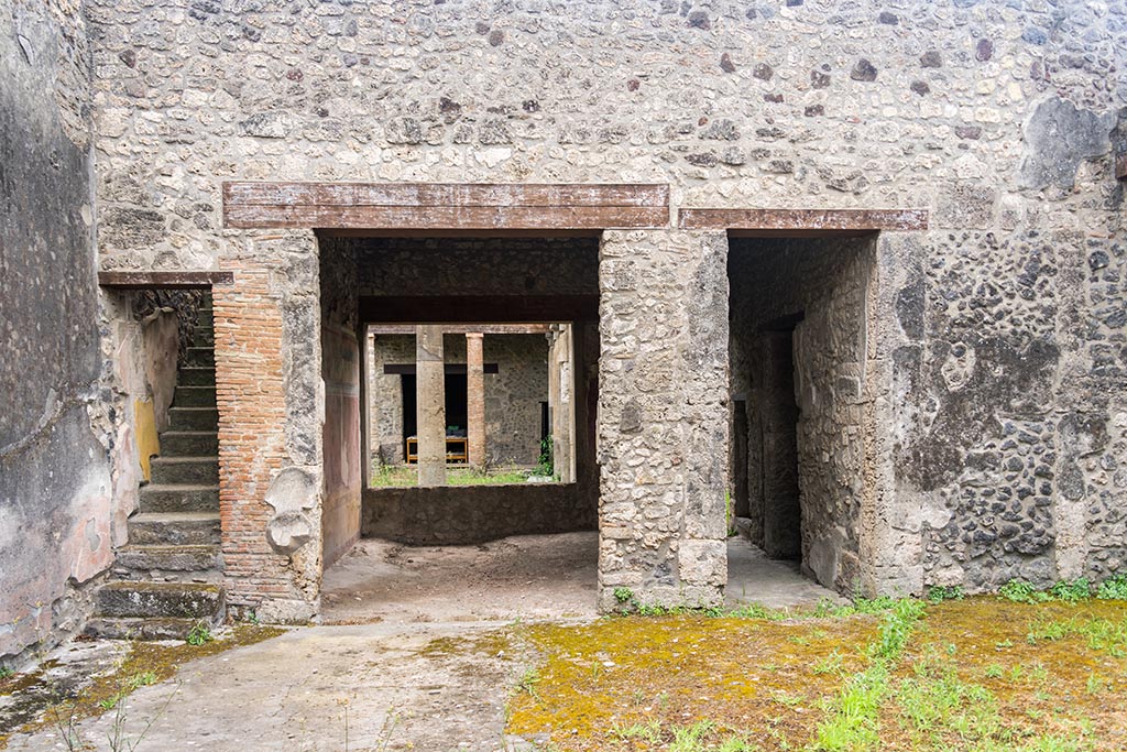 IX.14.4 Pompeii. July 2024.
Room 27, the secondary atrium at IX.14.2, looking south towards staircase, tablinum 19 and corridor. Photo courtesy of Johannes Eber.