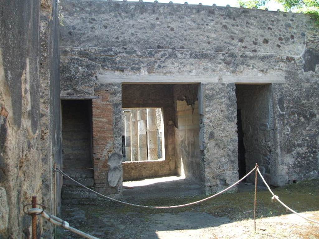 IX.14.4 Pompeii. May 2005. Room 27, the secondary atrium at IX.14.2, looking south to staircase, tablinum 19 and corridor (n). This area was excavated during June 1911. The floor of the atrium was made of concrete littered with chunks of white marble. Fragments of the wall decorations were found attached to the walls here and there. Renewal and restoration was being undertaken in 79AD. See Notizie degli Scavi, 1911, (p.267)