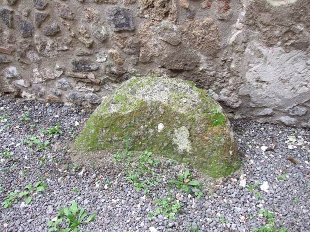 IX.14.4 Pompeii. December 2007. Round stone object in corridor (r), against west wall.