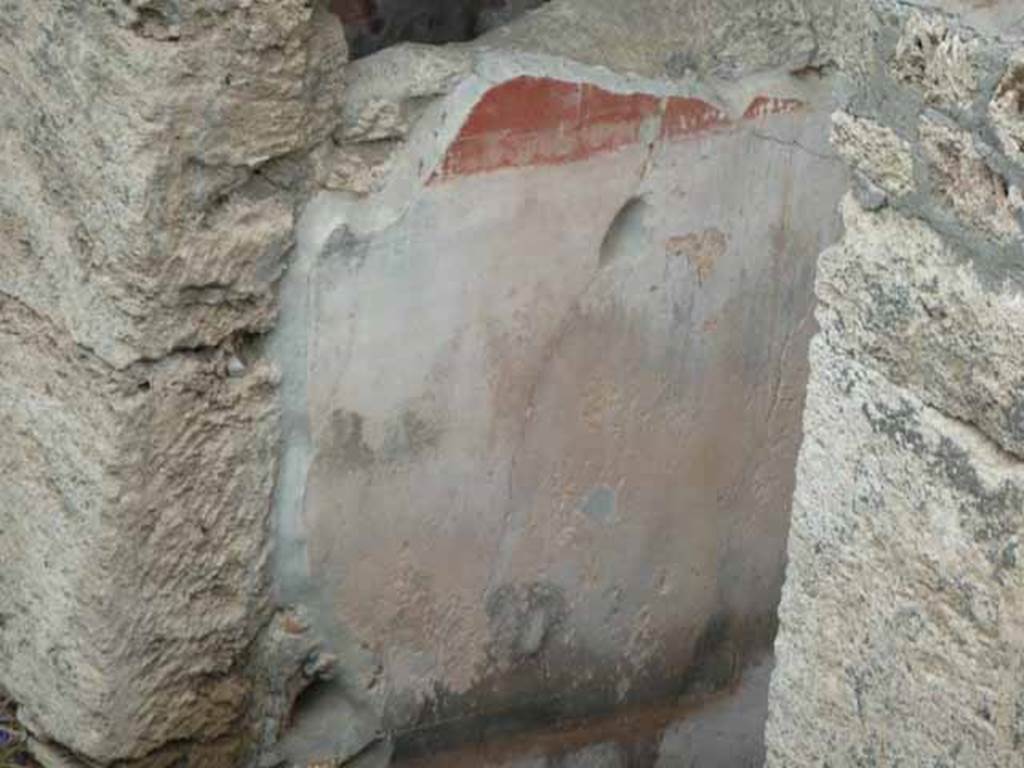 IX.14.c Pompeii. May 2010. Room 1, entrance corridor or fauces, north wall (left). The walls of the fauces or entrance corridor were painted with a black plinth, of large decorations likewise black. The red frieze was divided into rectangles by thin bands. The painting on the north wall was the best preserved. See Notizie degli Scavi di Antichità, 1911, p. 374.