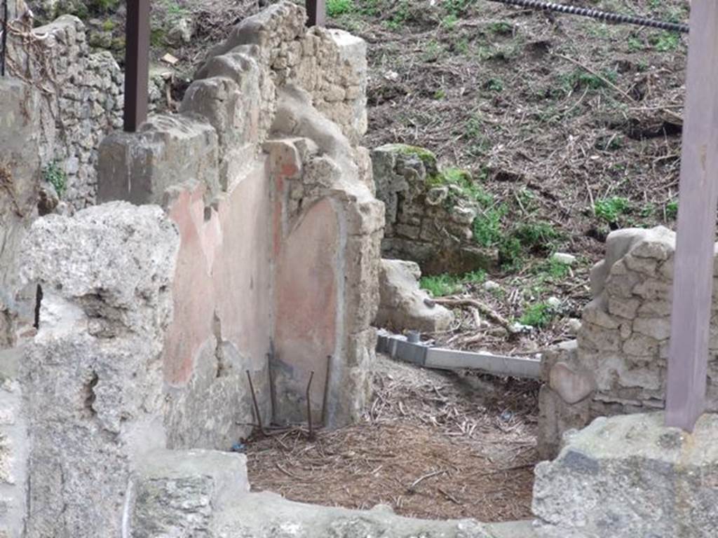 IX.14.c. December 2007. Looking south, across atrium 2 to doorway of room 7 on the south side. Photographed from roof of IX.14.2/4. According to NdS, to the left of the southern wall of the atrium was a low compartment, which formed the entrance to the large rectangular room, numbered 7. The concrete floor was painted red. The walls were decorated with a black plinth, large red decorated rectangles, and yellow frieze. The east wall had an entrance to a narrow room (numbered 8) in its centre, flanked by two small cupboards. Both cupboards preserved the traces of wooden shelving, and were coated with white plaster. The base of the side wall of one of the cupboard recesses can be seen (centre) in this photograph. Room 8 had a similar floor to room 7, as well as similar wall decorations. Very little of its walls were preserved. In the top of the east wall was a window overlooking the garden area 3.
