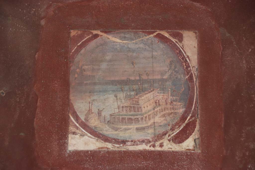 Villa San Marco, Stabiae. September 2019. Room 20, east wall, painted reproduction medallion of maritime villa. Photo courtesy of Klaus Heese.
(original now in Naples Archaeological Museum, inventory number 9409A.)