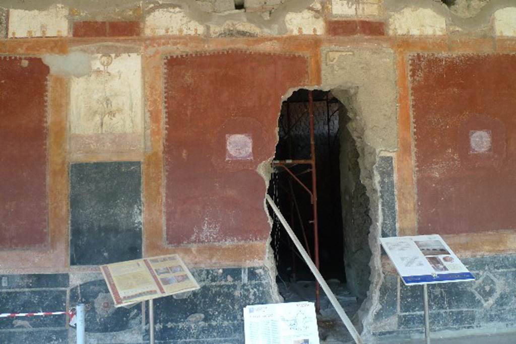 Castellammare di Stabia, Villa San Marco, July 2010. Room 20, east wall.
The reproduction medallion of a maritime scene (left) replaces one now in Naples Archaeological Museum, inventory number 9409B. The reproduction medallion of a maritime scene (right) replaces one now in Naples Archaeological Museum, inventory number 9408A. Photo courtesy of Michael Binns. The hole in the wall is a remnant of the 18th century tunnelling during the Bourbon excavation. This leads into the kitchen, room 26.