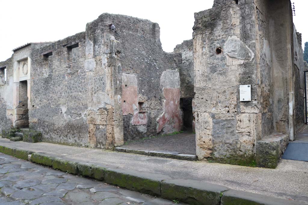Via dell’Abbondanza, Pompeii. December 2018. 
Looking east along II.2, from II.2.4, on left, with II.2.3, in centre, and II.2.2, on right. Photo courtesy of Aude Durand. 
