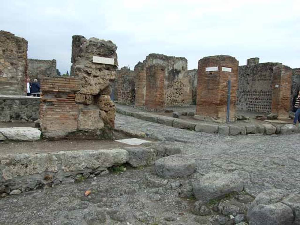 Via delle Terme, north side. May 2010.  Looking north to junction with Via Consolare, between VI.4 and VI.6.