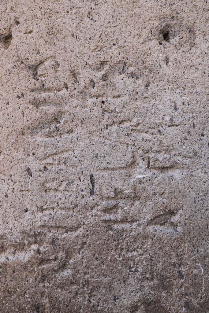 Vicolo degli Scheletri, Pompeii. December 2018.
Stone block with inscription at corner of Vicolo della Maschera and Vicolo degli Scheletri.
Photo courtesy of Aude Durand.