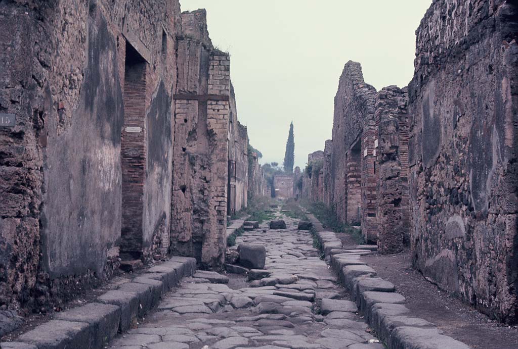 Vicolo dei Vettii, Pompeii. November 1966. 
Looking north between VI.13.16 (on left) and VI.14.36 towards junction with Vicolo di Mercurio. Photo courtesy of Rick Bauer.
