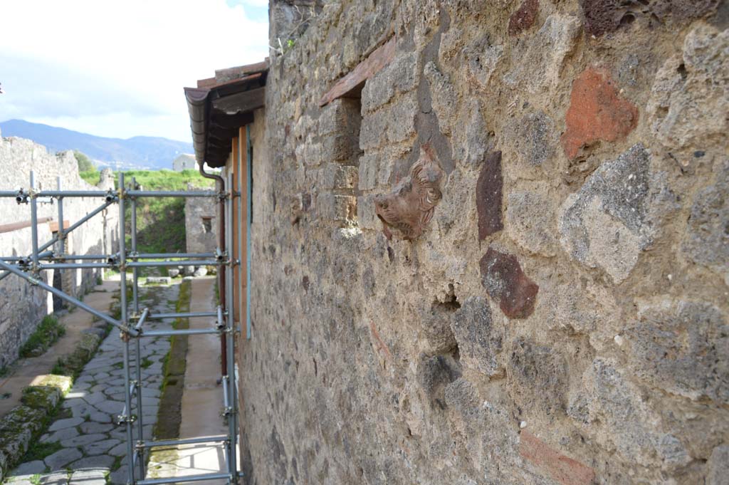 Vicolo del Centenario. March 2018.  
Looking south between IX.8, on left, and towards IX.5.14, in centre, with terracotta lion embedded in upper level masonry. 
Foto Taylor Lauritsen, ERC Grant 681269 DÉCOR.
