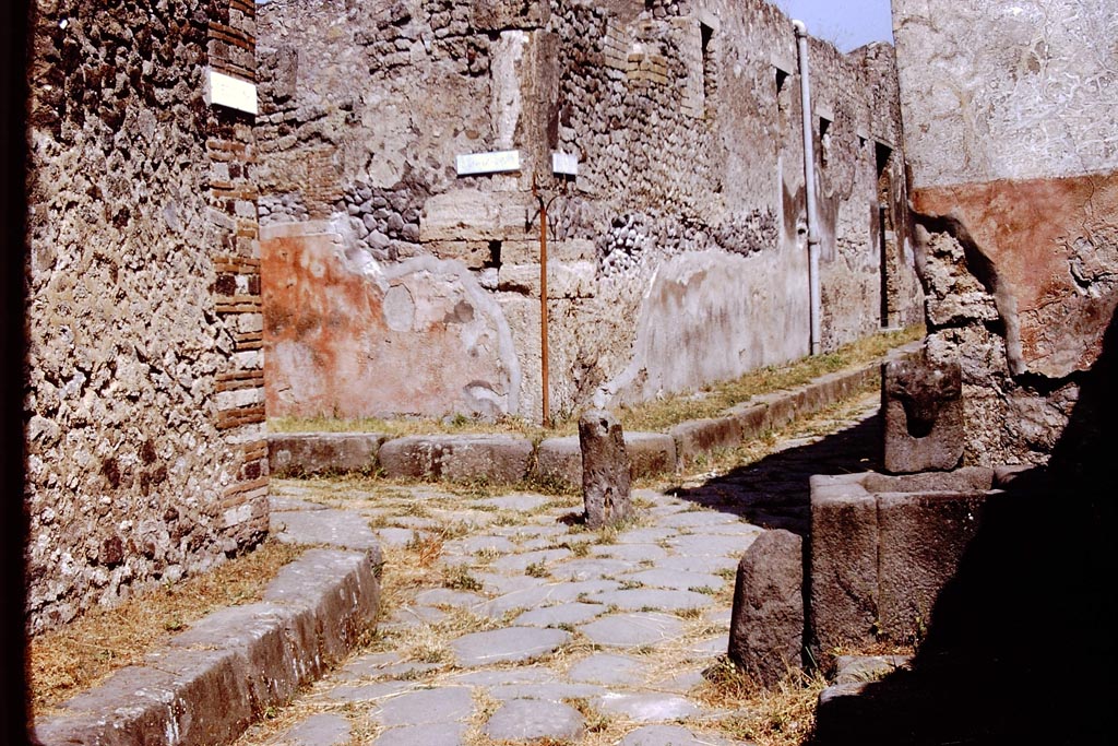 Vicolo di Tesmo, Pompeii. 1972. 
Looking north, with Vicolo di Balbo, on the left, and IX.7, on the right at rear of fountain. Photo by Stanley A. Jashemski. 
Source: The Wilhelmina and Stanley A. Jashemski archive in the University of Maryland Library, Special Collections (See collection page) and made available under the Creative Commons Attribution-Non-Commercial License v.4. See Licence and use details.
J72f0112

