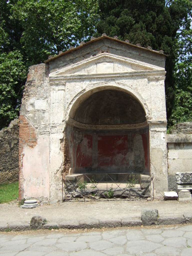 HGE09 Pompeii. May 2006. The tomb is a half round niche under an aedicula facade. It contains a seat and there is no obvious place for a burial and there are no finds.
According to Kockel it is either:
- A public seat built by a rich person.
- A Cenotaph with no provision for a burial.
- A burial place with the urn as yet to be found under the seat.
The context in which it stands leads him to favour it being a cenotaph or burial place.
See Kockel V., 1983. Die Grabbauten vor dem Herkulaner Tor in Pompeji. Mainz: von Zabern. (p. 161).