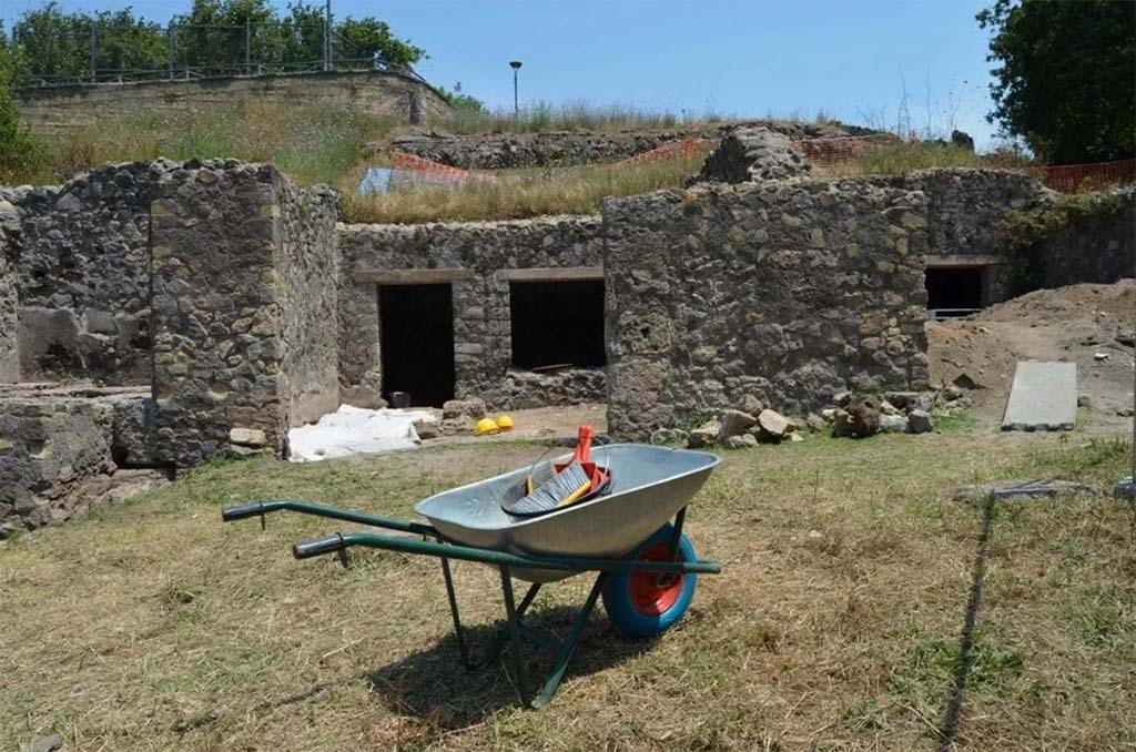 HGE20 Pompeii. June 2016. The shop where the five fugitives had taken refuge.
Here the archaeologists, while emptying the rooms of a workshop already explored in the nineteenth century by Giuseppe Fiorelli, came across a layer untouched by the nineteenth-century excavators and found the skeletons of five fugitives, who had found refuge in the workshop while trying to escape the fury of the eruption of Vesuvius in 79 AD: Alongside the bones, three gold coins, a necklace pendant and some tableware were found, mixed together after the looting by clandestine diggers who ventured into the workshop after the eruption of 79 AD. They had ventured into the city in search of treasures buried under the ashes. The area was damaged by bombing in 1943.
La bottega dove si erano rifugiati i cinque fuggiaschi.
Qui gli archeologi, mentre svuotavano gli ambienti di una bottega già esplorata nell'Ottocento da Giuseppe Fiorelli, si sono imbattuti uno strato non intaccata dagli scavatori ottocenteschi e hanno rinvenuto gli scheletri di 5 fuggiaschi, che avevano trovato rifugio nella bottega mentre cercavano si sfuggire alla furia dell'eruzione del Vesuvio del 79 dopo Cristo: accanto alle ossa sono state ritrovate tre monete d’oro, un pendente di collana e alcuni vasi da mensa, mescolati alla rinfusa dopo i saccheggi degli scavatori clandestini che dopo l’eruzione del 79 d.C. si avventurarono nella città alla ricerca di tesori sepolti sotto la cenere. La zona fu danneggiata dal bombardamento del 1943.
Photograph © Parco Archeologico di Pompei.