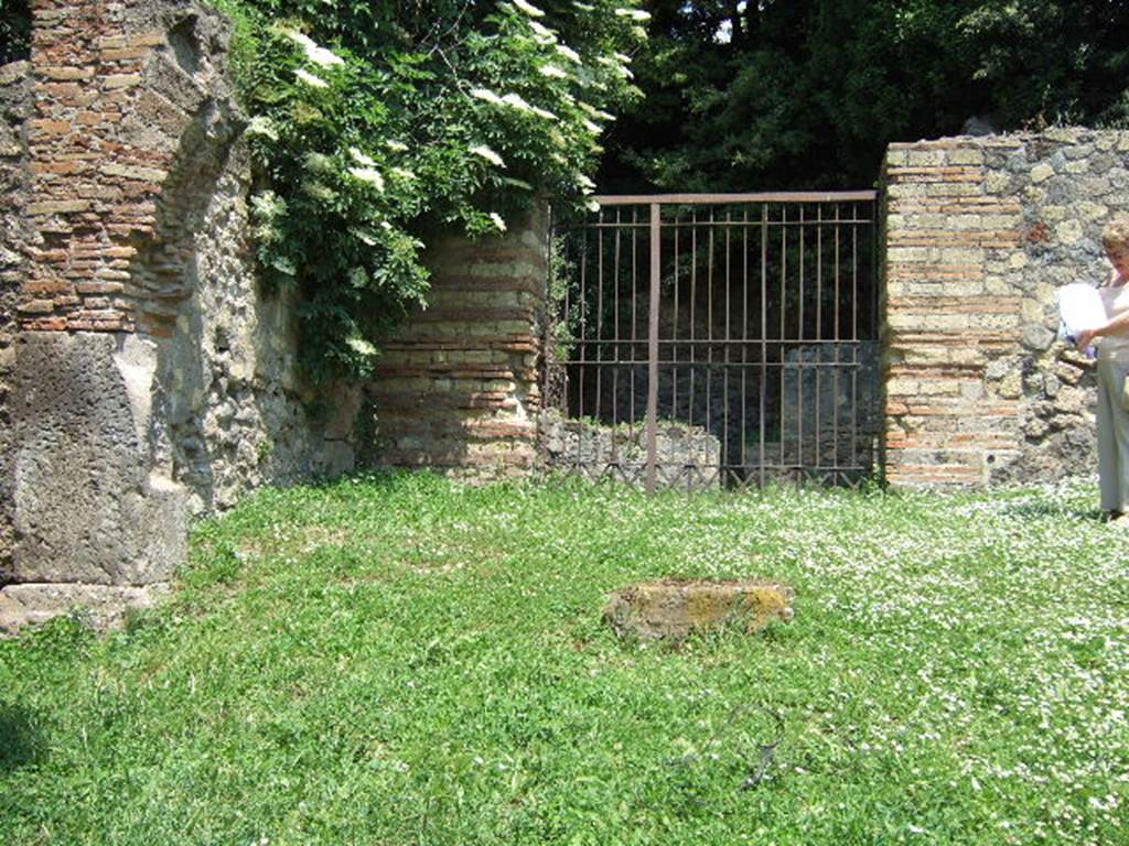 HGE29 Pompeii. May 2006. Looking east to entrance doorway to rooms 1 and 2.
According to Mau, a potter’s workshop with two ovens was located here. The ovens which were not large, had an upper division in which were placed the vessels to be baked. Beneath this was a firebox, underneath the floor above being pierced with holes to let the heat through. The vault of one of the ovens was constructed of parallel rows of jars fitted into one another. See Mau, A., 1907, translated by Kelsey, F. W., Pompeii: Its Life and Art. New York: Macmillan. (p. 386).
According to Garcia y Garcia, a bomb fell during the night of 18th September 1943 thoroughly hitting the workshop. This destroyed the two rooms, 29 and 30, with their respective ovens. See Garcia y Garcia, L., 2006. Danni di guerra a Pompei. Rome: L’Erma di Bretschneider. (p.163)