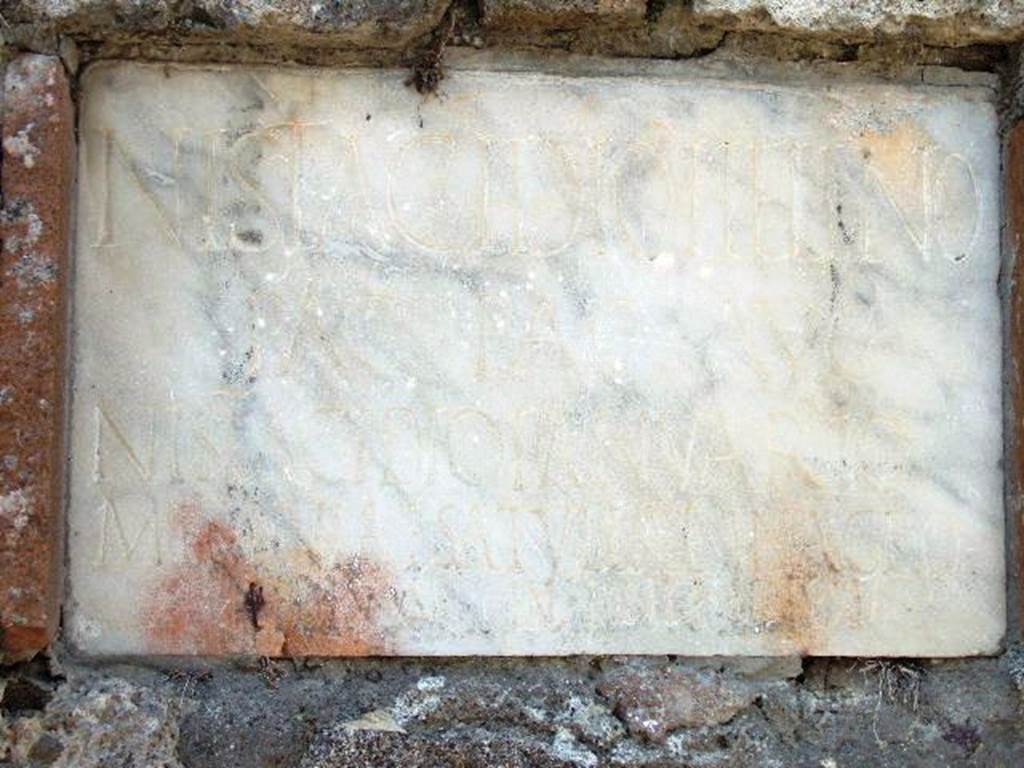 HGW21 Pompeii. May 2006. Marble plaque with Latin inscription.

N ISTIDACIO HELENO
PAG PAG AVG
N ISTADACIO IANVARIO
MESONIAE SATVLLAE IN AGRO
PEDES XV IN FRONTE PEDES XV
See Bonucci C., 1830. Pompei: 3rd edition. Naples: limprimerie Francaise. (p. 55-6).

According to Epigraphik-Datenbank Clauss/Slaby (See www.manfredclauss.de) this reads

N(umerio) Istacidio Heleno
pag(ano) pag(i) Aug(usti)
N(umerio) Istacidio Ianuario
Mesoniae Satullae in agro
pedes XV in fronte (p)edes XV      [CIL X 1027]

According to Cooley this translates as

To Numerius Istacidius Helenus, inhabitant of the Auigustan Country District; 
To Numerius Istacidius Ianuarius; 
To Mesonia Satulla. 
15 feet deep, 15 feet broad.

See Cooley, A. and M.G.L., 2004. Pompeii : A Sourcebook. London : Routledge. (p. 132, F99).