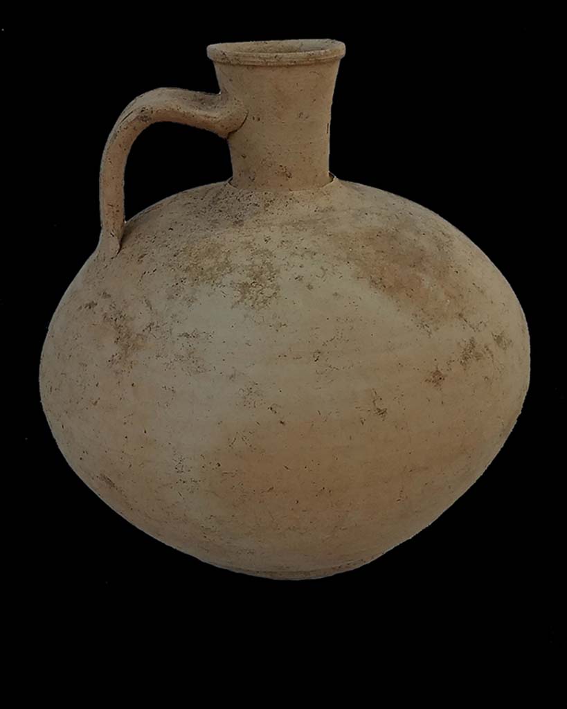 Tomb NG3 Pompeii. August 2017. In 2017 progressing westward the excavation identified two tombs where only the funerary stele had previously been recovered.
The excavation discovered both the cremation urns which had been placed behind the stele, the second of which, 0.40m behind the burial marker, belonging to L. Manilius Saturninus, was accompanied by a small jug and animal bones.
The fill around the cremation urn was composed mostly of ash, although large pieces of wood and numerous nails were also recovered, presumably part of a grave goods assemblage.
See Pompeii Porta Nola Necropolis Project in Papers of the British School at Rome: Vol. LXXXVI, 2018, pp. 314-5.
Photo courtesy Stephen Kay, British School at Rome.