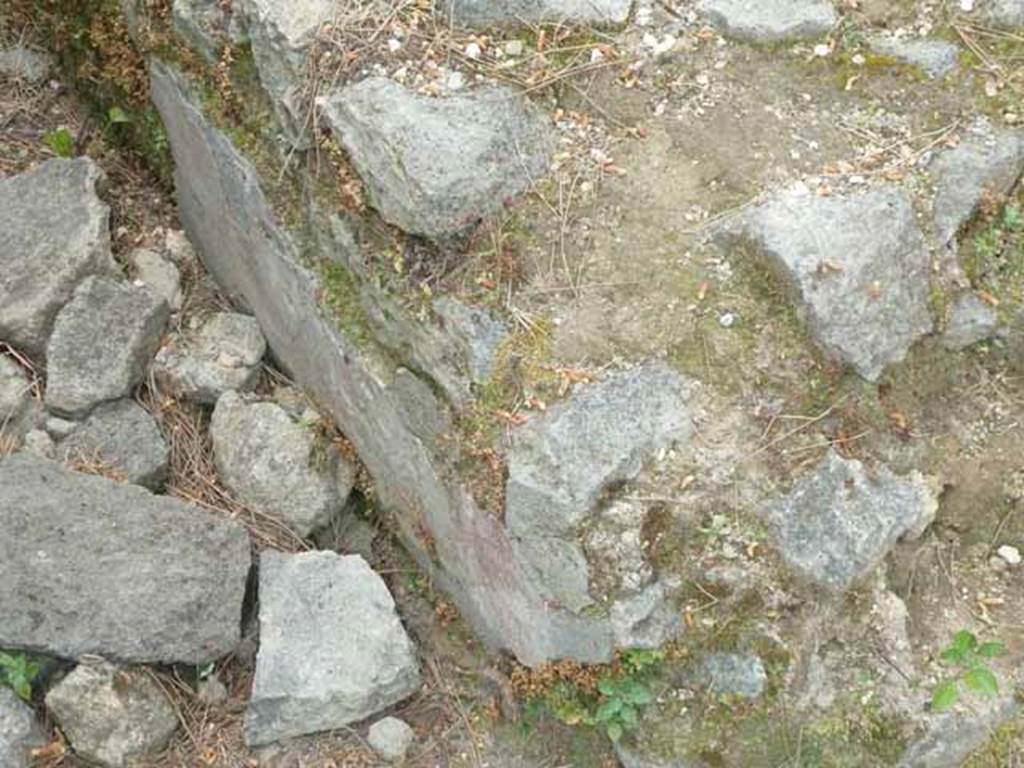 Pompeii Porta Nocera. Tomb 3ES. Lower corner, with remains of painted plaster. May 2010.