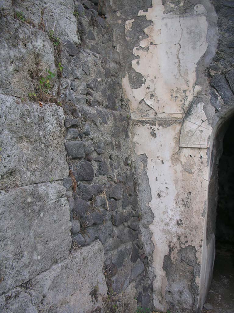 Tower VI, Pompeii. May 2010. 
Detail of city wall and remaining stucco on upper west doorway.Photo courtesy of Ivo van der Graaff.
