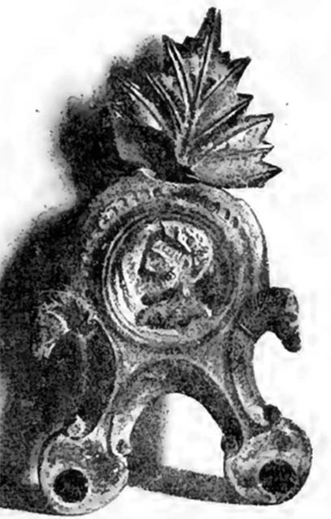 Villa of T. Siminius Stephanus, fondo Barbatelli. November 1899. A large glazed terracotta lamp with two lights: in the shield was seen in relief a bust with the head in profile, turning to the left. The head was graduated and bearded, and on his right shoulder rests the sceptre (Jupiter?). At the sides of the shield, two scrolls with the heads of horses. On the back of the leaf that surmounts the handle of enamelled terracotta lamp, following the cleanup of the lamp, were found the initials L N I. See Notizie degli Scavi di Antichit, 1899, p. 445, fig. 7, p. 494.