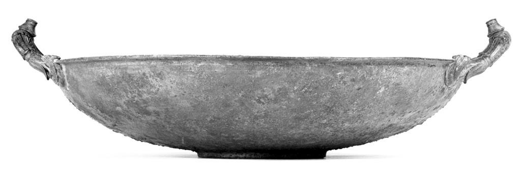 Villa in Boscoreale. Bronze basin, undecorated except for the serpentine handles which are fashioned with floral motifs. 
At the apex of each is a raised knob.
Digital image courtesy of the Getty's Open Content Program. Now in the Getty Museum, inventory number 72.AC.141.
