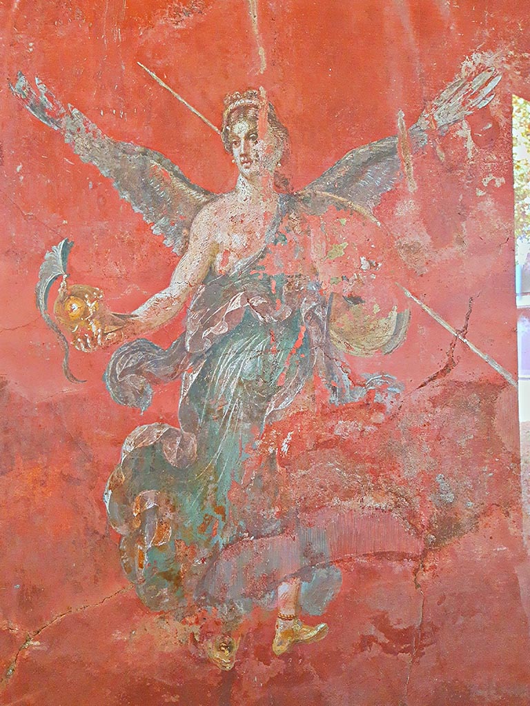 Complesso dei triclini in località Moregine a Pompei. September 2024.
Triclinium C, west wall. Winged Victory with the attributes of Athena. Photo courtesy of Giuseppe Ciaramella.

