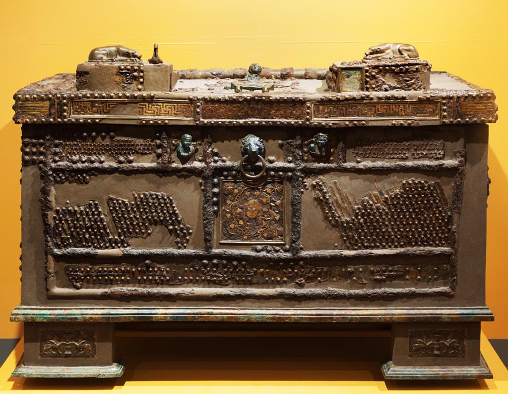 Oplontis, Villa of Lucius Crassius Tertius. Found in the peristyle, Strongbox with inscription.
According to a Soprintendenza information stand at Oplontis, this chest was found empty. 
It must, however, have been intended for precious items in view of the complex locking mechanism it had.
According to the Oplontis Project, the strongbox, found in the peristyle, may have fallen from the upper floor.  
It had a wooden framework plated with iron leaves and was inscribed “Pythonymos, Pytheas, and Nikokrates, the workers of Herakleides, made [this].” 
Its exquisite decoration consists of inlay designs and figural bosses in silver, copper, and gilded bronze typical of late Hellenistic decorative design.  
Furthermore, its intricate locking system was so advanced that similar mechanisms continued in use until the nineteenth century.
See Oplontis Project Paragraph 133
