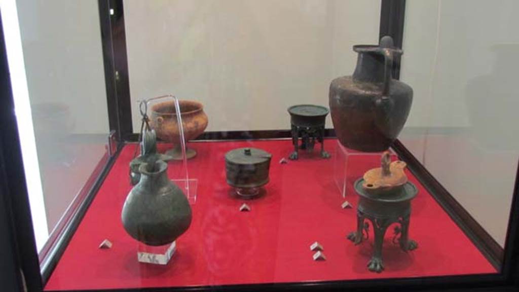 Gragnano, Villa rustica in Località Carmiano, Villa A. Items found in various rooms.
Stabiae Antiquarium, inventory numbers
63539 jug found in room 6.
63437 bronze perfume holder found in room 1.
63464 cup found in room 7.
63528 pyx found in room 9.
63278 (rear) 63279 (front) lamp stands found in room 2.
63543 lamp found in room 6.
63377 jug found in room 4.
Photo courtesy of Donna Dollings.
