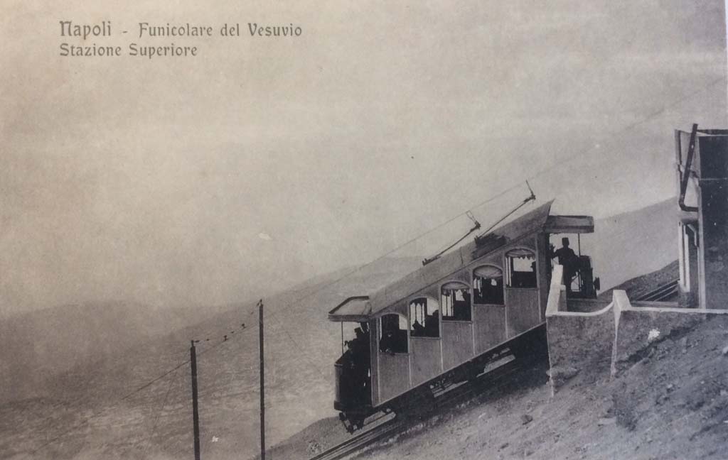 Postcard for Vesuvius Railway and Funicular. Not dated but the funicular car is the monorail in use up to 1904. 
It also shows a horse drawn carriage, a Vesuvius eruption and the route up Vesuvius.
A round trip in 1886 with guides from Naples to the summit by horse carriage and funicular cost about a pound, a high figure for the time.
Photo courtesy of Rick Bauer.
